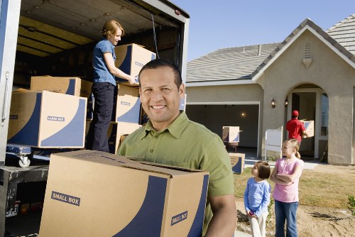 Local movers carrying items through a Kings Cross apartment building